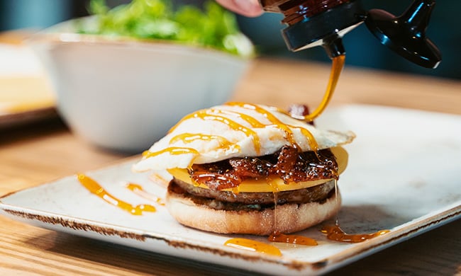 Mike's hot honey drizzled on the Million Dollar Breakfast Sandwich