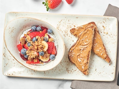 Coconut milk chia seed pudding, fresh bananas and berries, mixed berry compote, housemade granola with almonds and our whole grain artisan toast with almond butter and Maldon sea salt.