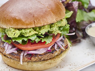 A lean white-meat turkey patty with avocado, organic mixed greens, housemade pico de gallo, mayo and Horseradish Havarti cheese on a brioche bun.