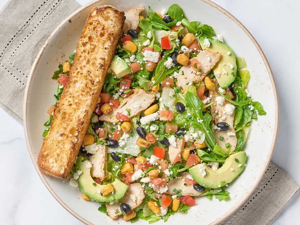 Chopped romaine and arugula, all-natural chicken breast, avocado, tomatoes, corn, black beans, Feta cheese and crispy tortilla strips with citrus chipotle dressing.