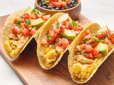 Three wheat-corn tortillas with scrambled cage-free eggs, Cajun chicken, chorizo, Cheddar and Monterey Jack. Topped with fresh avocado and housemade pico de gallo. Served with seasoned black beans.