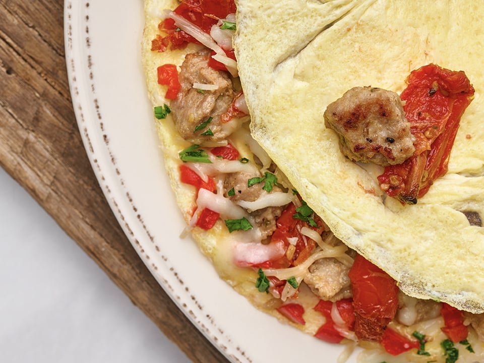 Italian sausage, house-roasted tomatoes and red peppers with fresh herbs, Mozzarella and Parmesan.