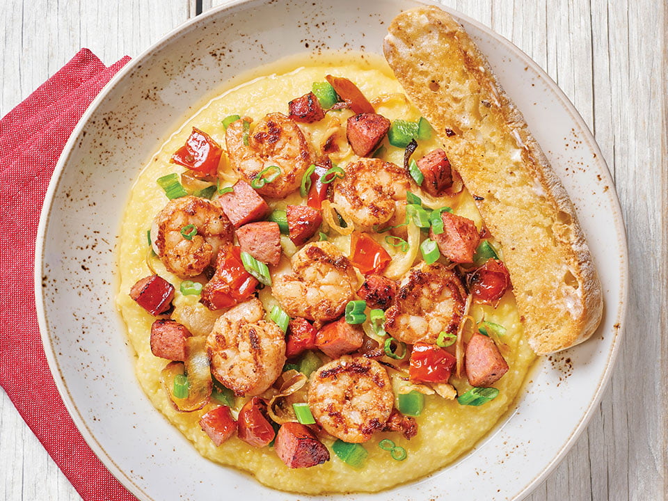 Sautéed Cajun shrimp and andouille sausage cooked Lowcountry-style with chicken stock, house-roasted tomatoes and onions, diced green bell peppers and scallions atop Bob’s Red Mill Cheddar Parmesan cheese grits. Served with artisan ciabatta toast.