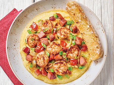 Sautéed Cajun shrimp and andouille sausage cooked Lowcountry-style with chicken stock, house-roasted tomatoes and onions, diced green bell peppers and scallions atop Bob’s Red Mill Cheddar Parmesan cheese grits. Served with artisan ciabatta toast.