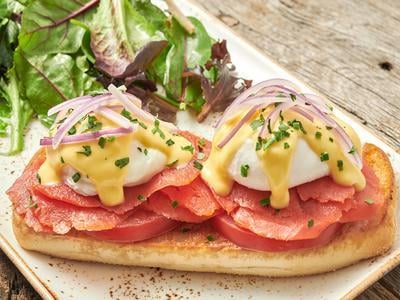 Two poached cage-free eggs atop toasted ciabatta with Wild Alaska Smoked Sockeye Salmon, red onion and vine-ripened tomato and covered with hollandaise. Served with lemon-dressed organic mixed greens.