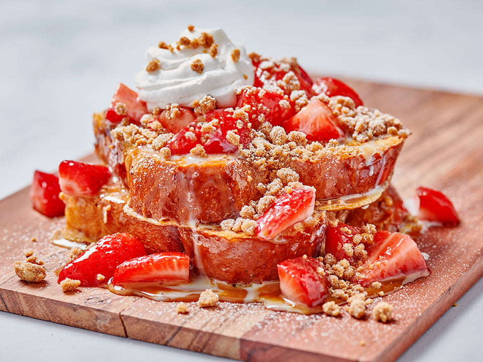 Thick-cut, custard-dipped, griddled challah bread, macerated strawberries, warm dulce de leche, whipped cream and spiced gingerbread cookie crumbles. Lightly dusted with powdered cinnamon sugar.