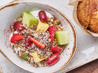 Non-fat vanilla Greek yogurt layered with fresh, seasonal fruit and our housemade granola with almonds. Served with a freshly baked muffin of the day.