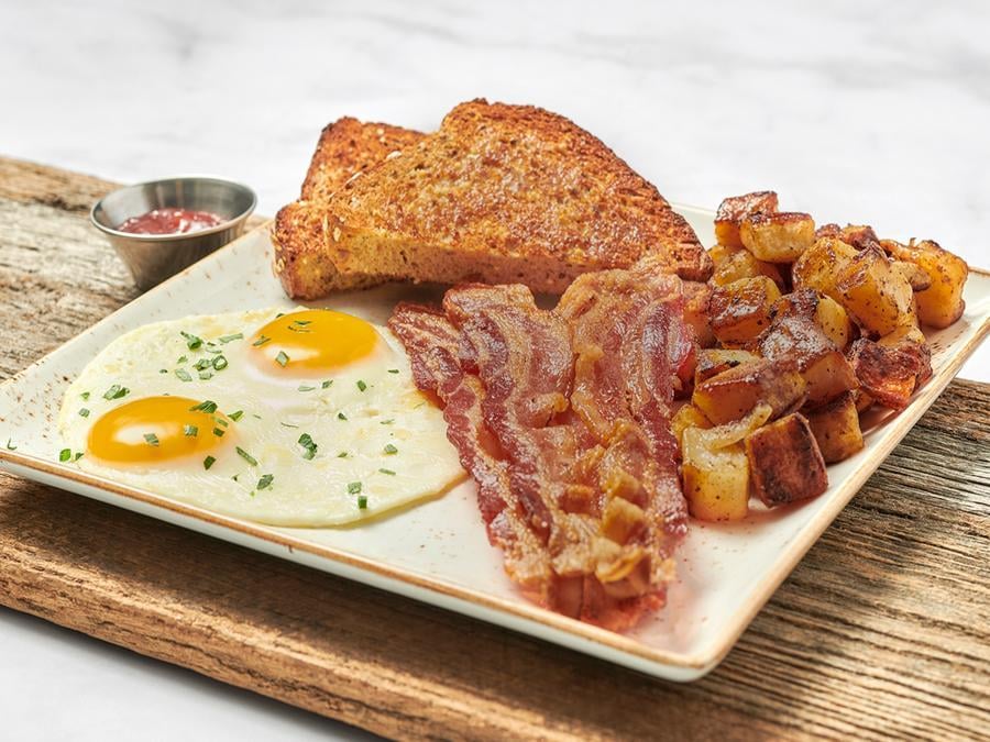 Two cage-free eggs any style with your choice of bacon, smoked ham, chicken apple sausage patties, turkey or pork sausage links. Served with our whole grain artisan toast, all-natural house preserves and fresh, seasoned potatoes. Substitute gluten-free toast at no additional charge.