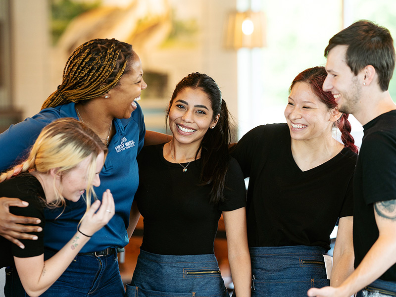 First Watch employees gathered together, laughing